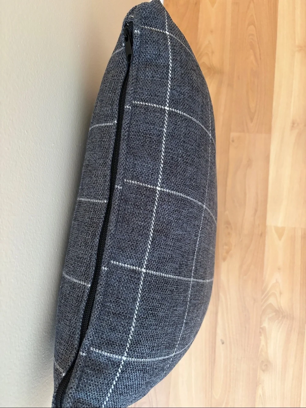 Gray and white checker accent pillow with side zipper.